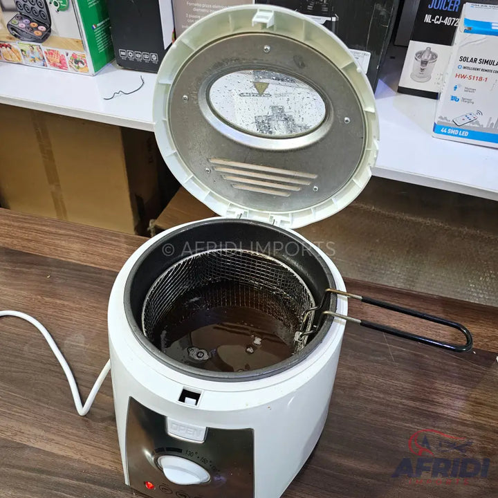 A white electric deep fryer with an open lid, a removable frying basket, and a temperature control dial.