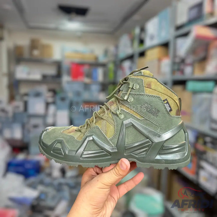 A pair of green and camouflage outdoor hiking boots with a durable sole and ankle support.