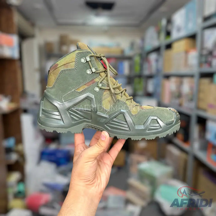 Olive green lace-up hiking boot with a rugged sole.