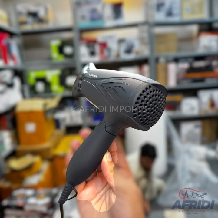 Black, compact hair dryer with a folding handle.