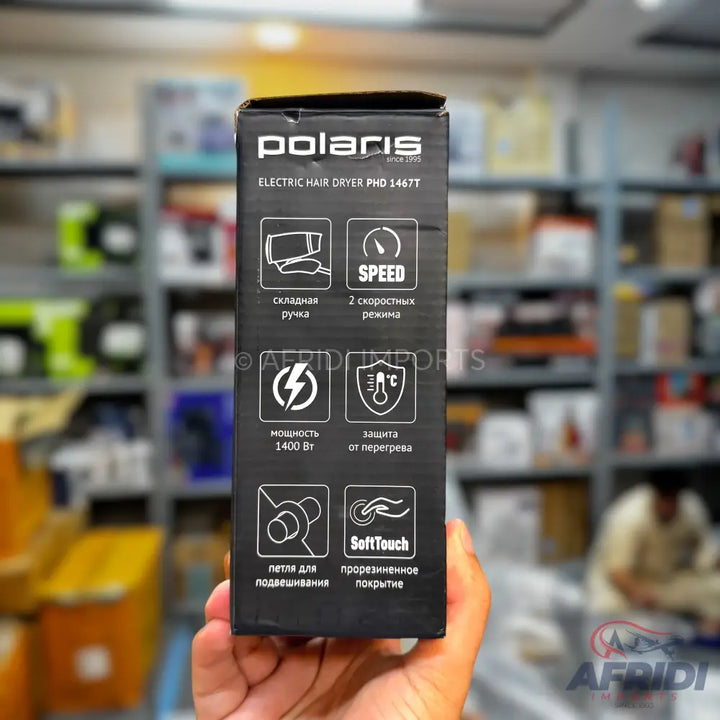 Black box for a Polaris electric hair dryer with features like a folding handle, 2 speed settings, 1400W power, overheat protection, hanging loop, and SoftTouch coating.