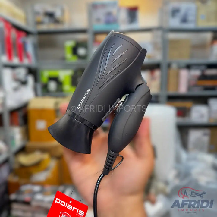 Black hair dryer with a textured body and a foldable handle.