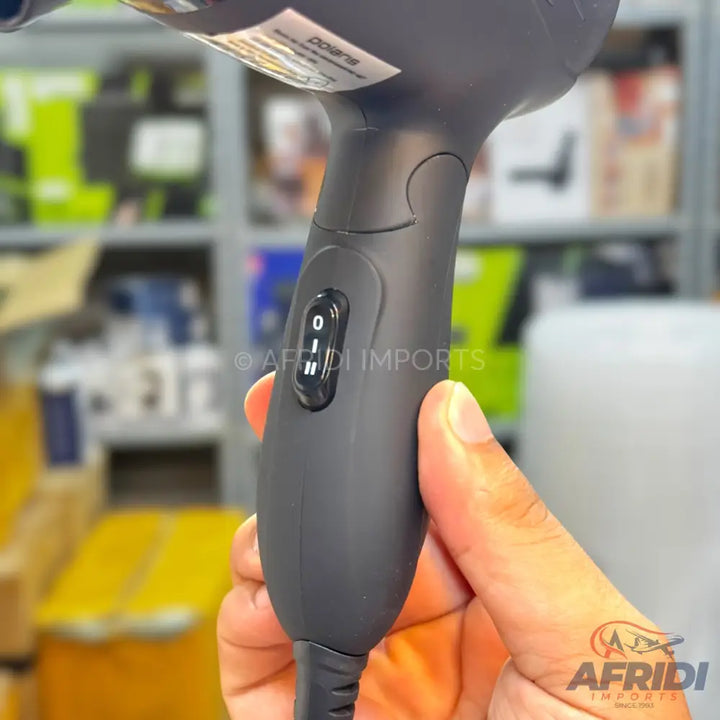 A dark-colored hairdryer with a three-setting slide switch for power or heat control.