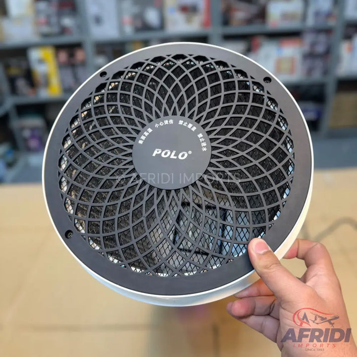 Round electric air purifier with a decorative black mesh grill.