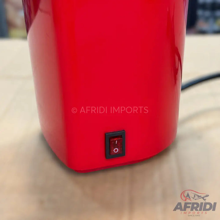 Red electric beverage dispenser with an on/off switch.