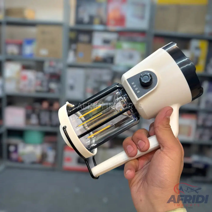 A portable, handheld insect zapper with a white body, a black top, a clear zapping chamber containing yellow and black rods, and a rotatable power switch with four indicator lights.