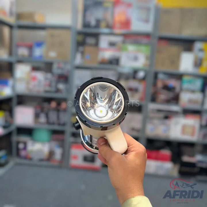 A white and black handheld flashlight with a single LED bulb.