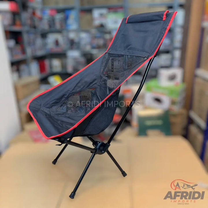 Black and red portable camping chair with mesh back.