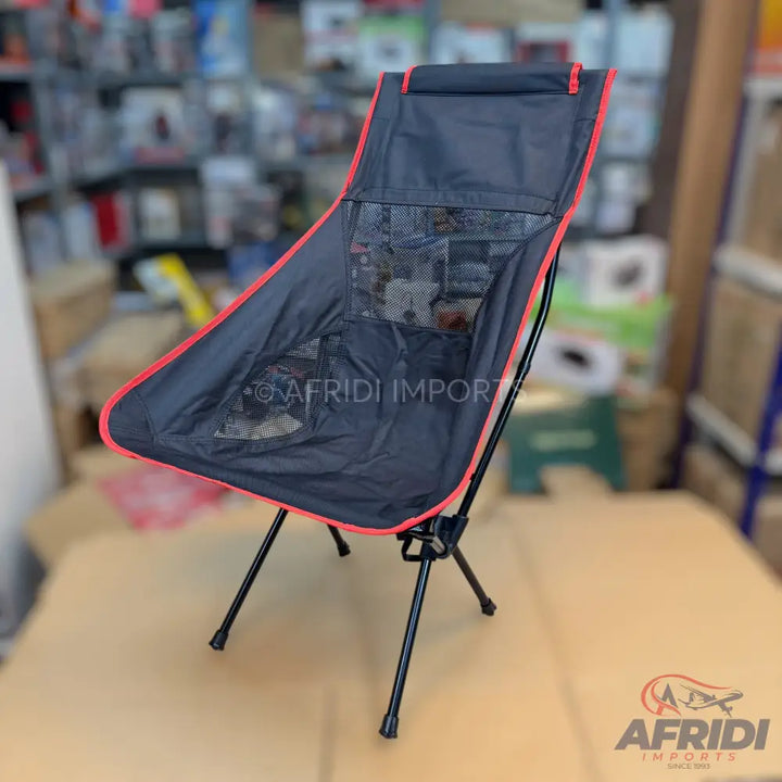 Black and red portable folding camping chair with mesh pockets.