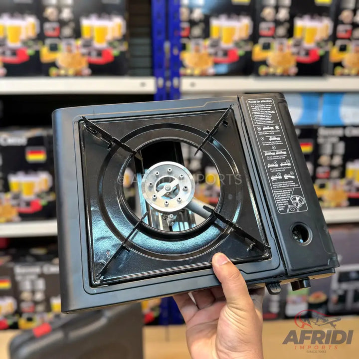 Black portable single-burner gas stove with a built-in igniter.
