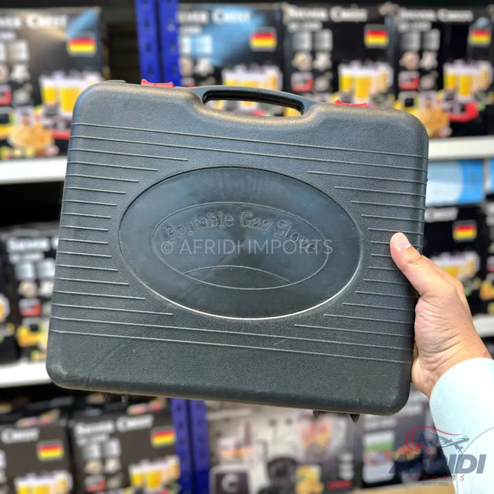 Black portable gas stove in a protective carrying case.