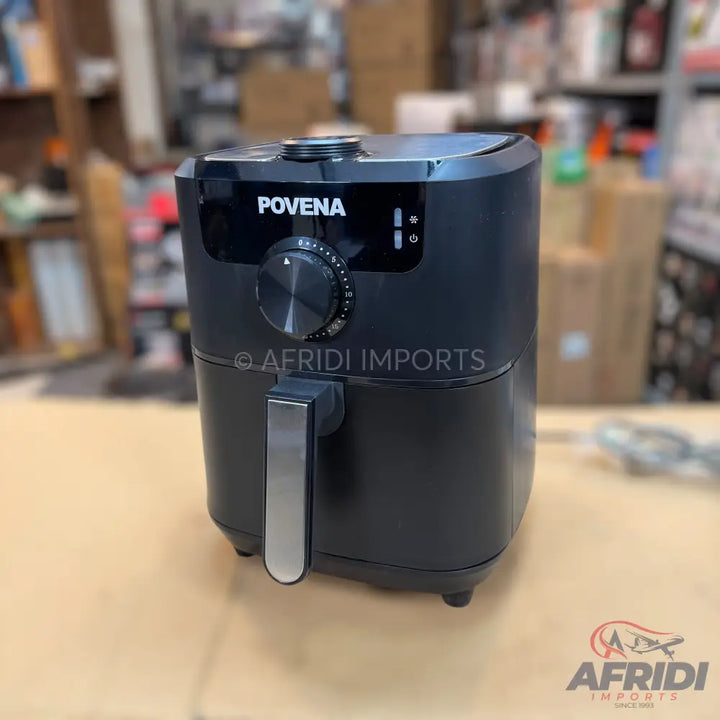 Black digital air fryer with a stainless steel handle and a visible control knob.