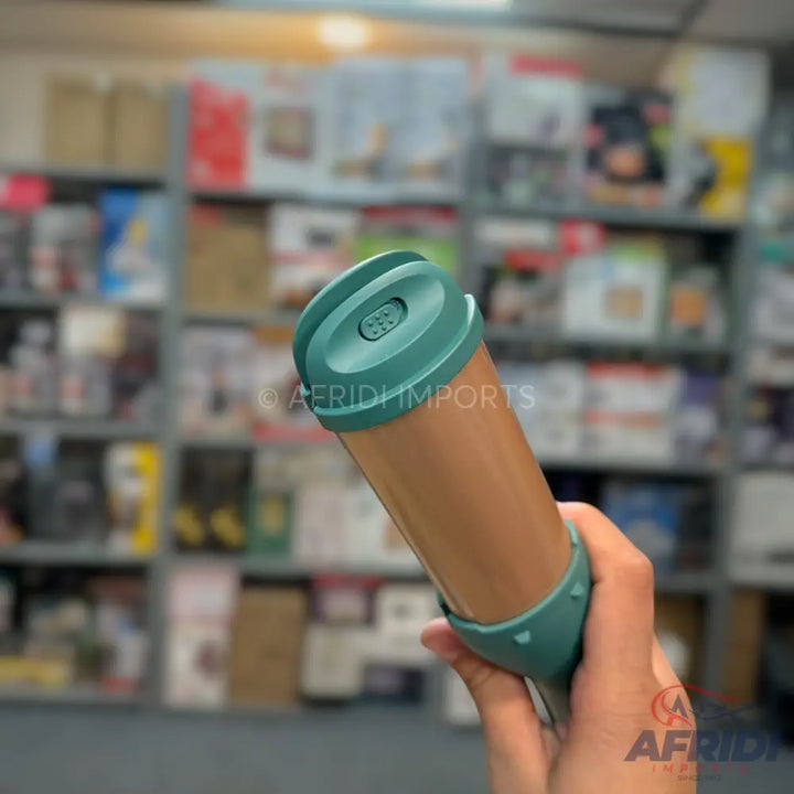 A handheld, portable dog water bottle with a teal cap and a brown body.