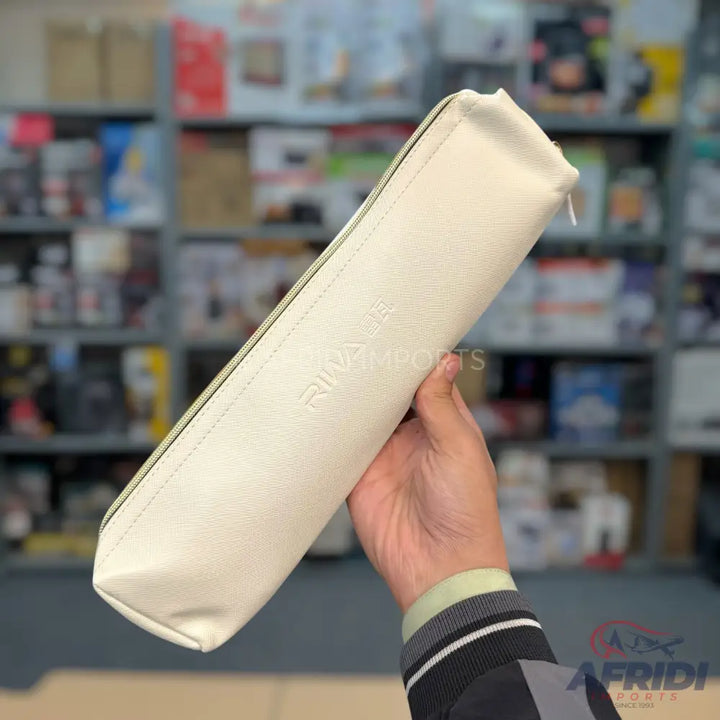 A cream-colored, rectangular zippered pouch made of a textured material.