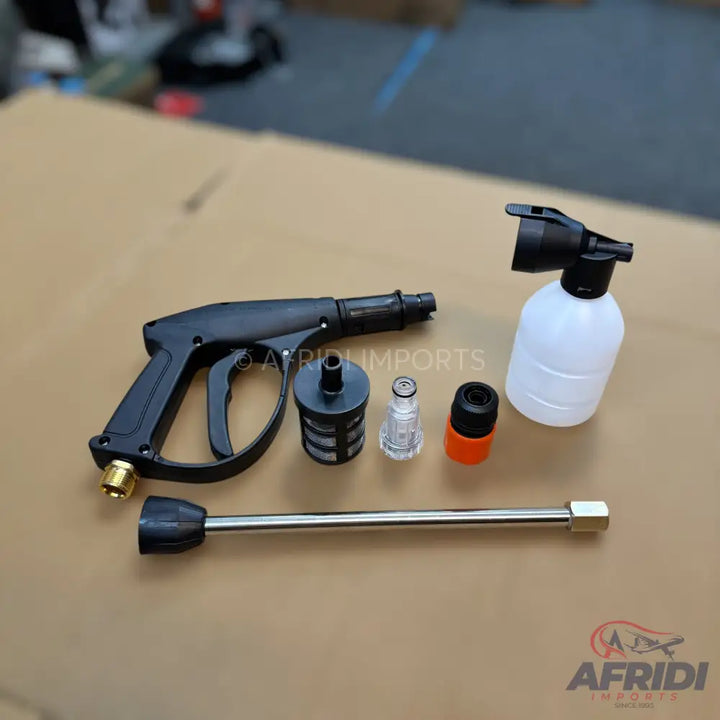 Black and silver pressure washer gun with accessories.