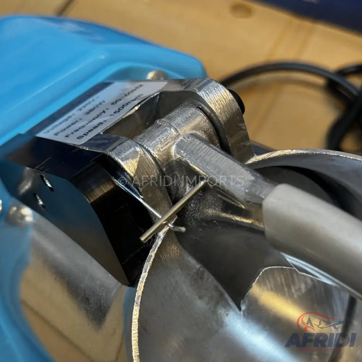 A metallic water pump with a light blue top housing.