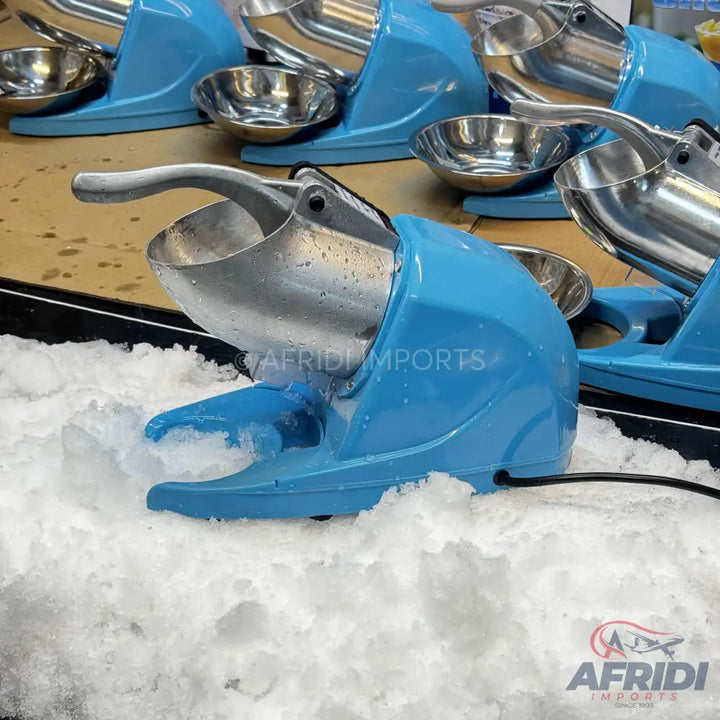 Light blue electric ice shaver with a metal hopper and handle.