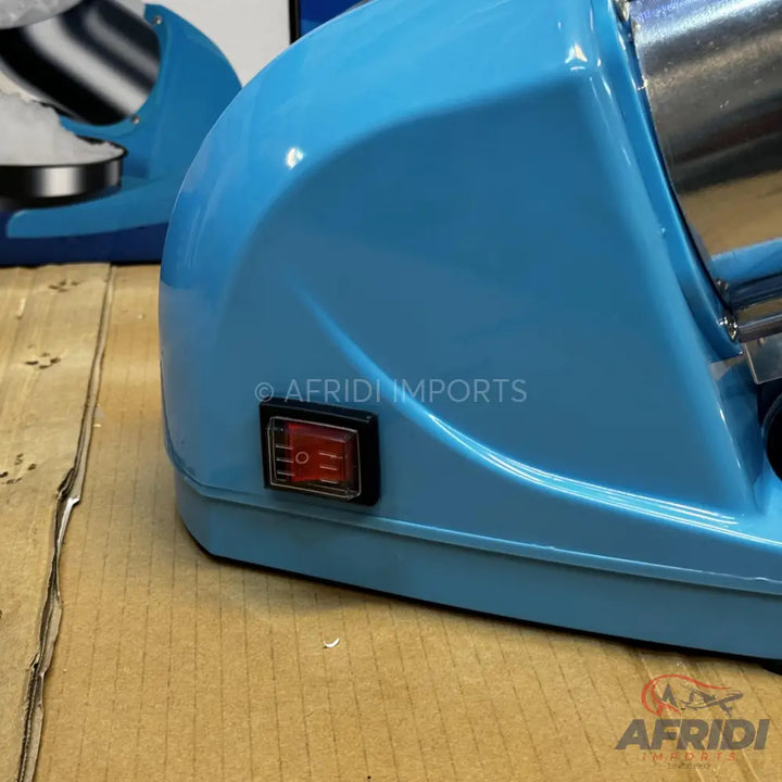 A light blue electric ice shaver with a red power switch.