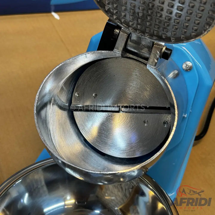 Light blue electric ice shaver with a stainless steel hopper and shaving mechanism.