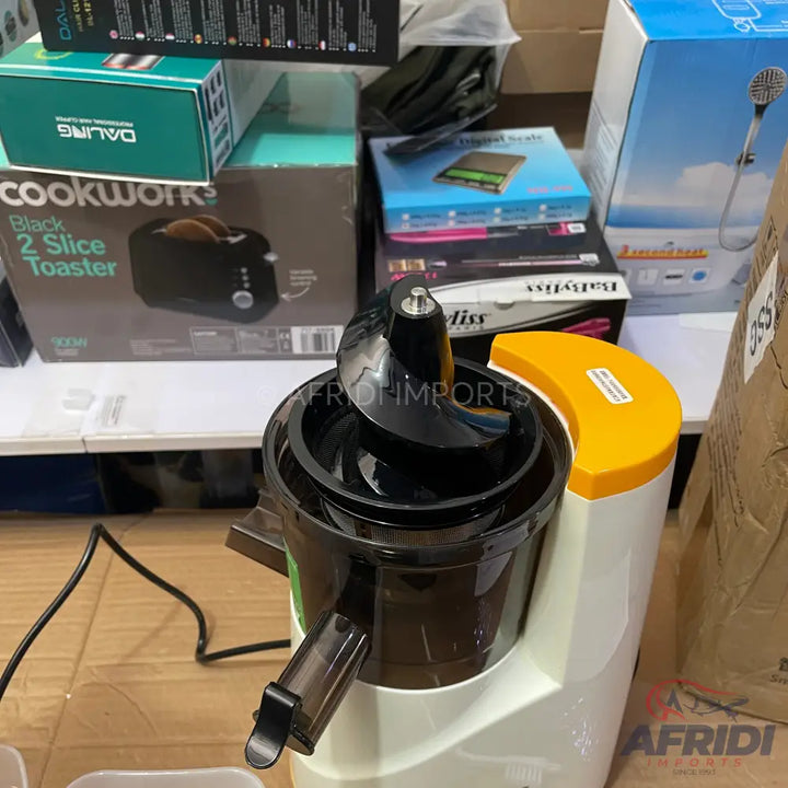 An upright slow juicer with a white base, black processing components, and a yellow top cap.