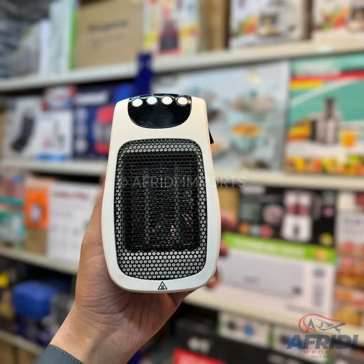 White portable electric space heater with a black gridded front and control buttons on top.