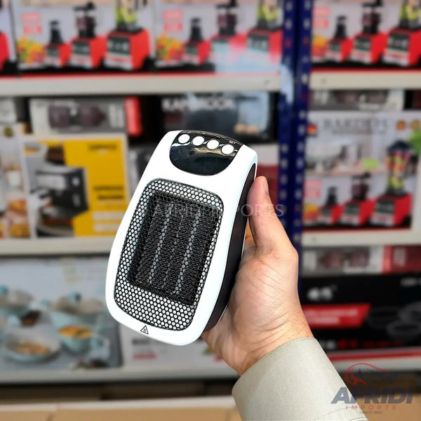 A white and black portable electric heater with a mesh grill.