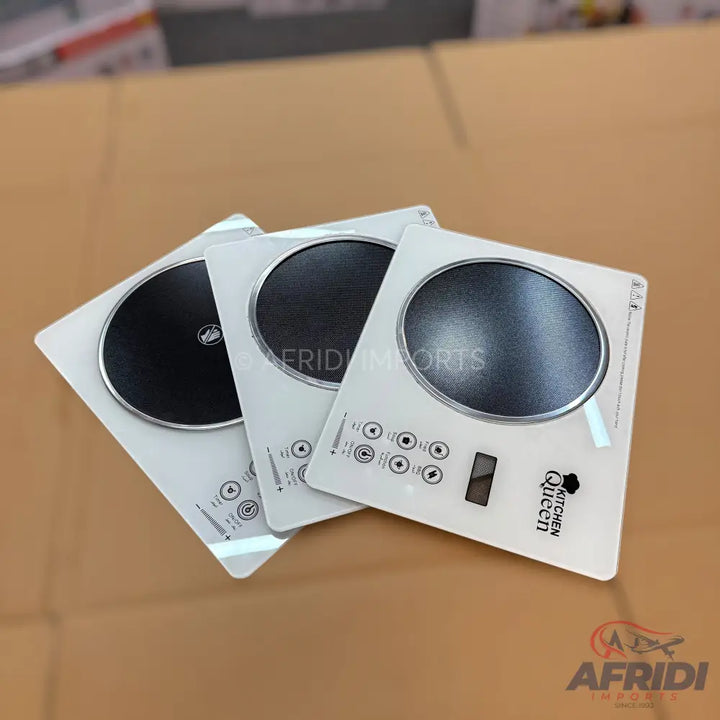 Three white portable induction cooktops with black cooking surfaces.