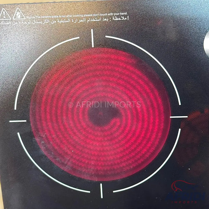 Black induction cooktop with a glowing red spiral heating element.