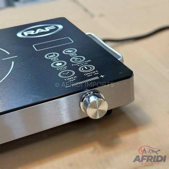 Black and silver portable induction cooktop with touch controls and a rotary knob.