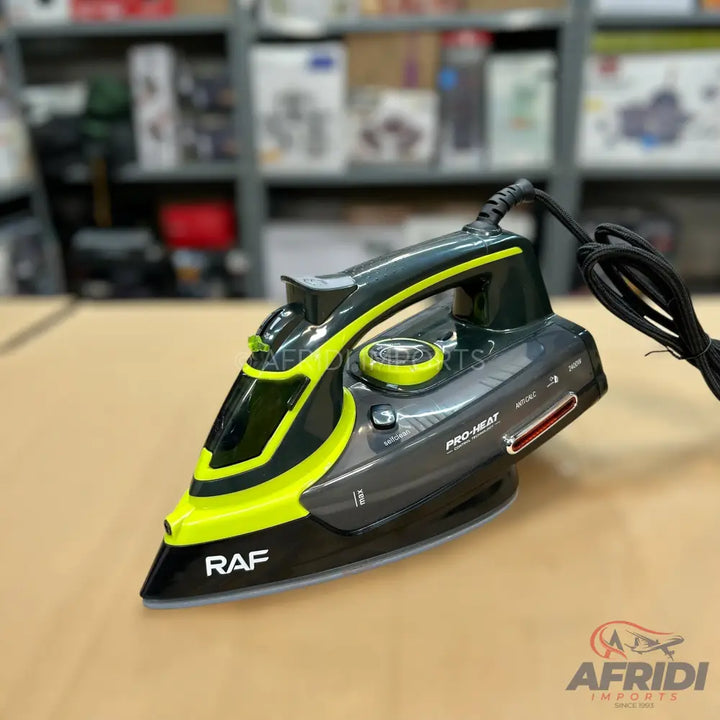 Dark gray and neon green steam iron with a black power cord.