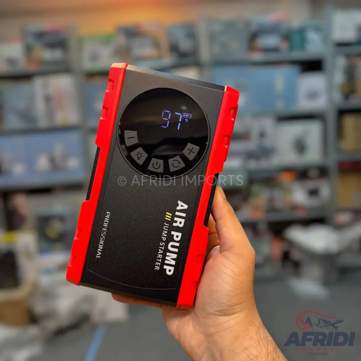 Red and black portable air pump and jump starter with a digital display and control buttons.