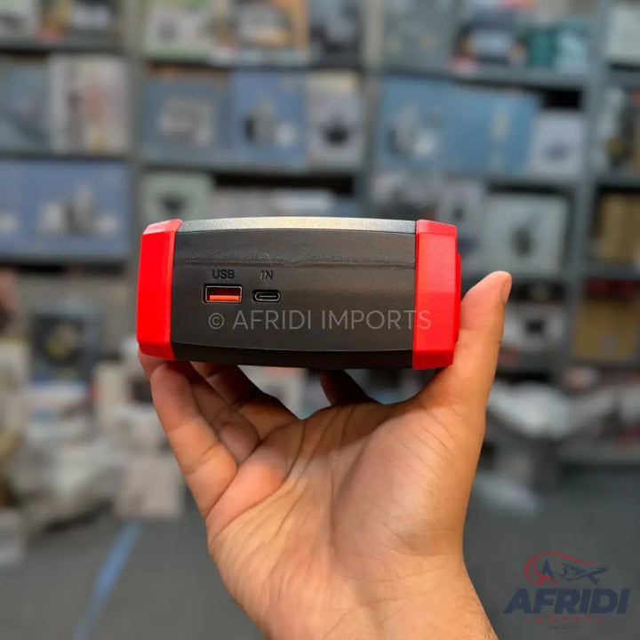 Black and red portable power bank with USB and USB-C ports.