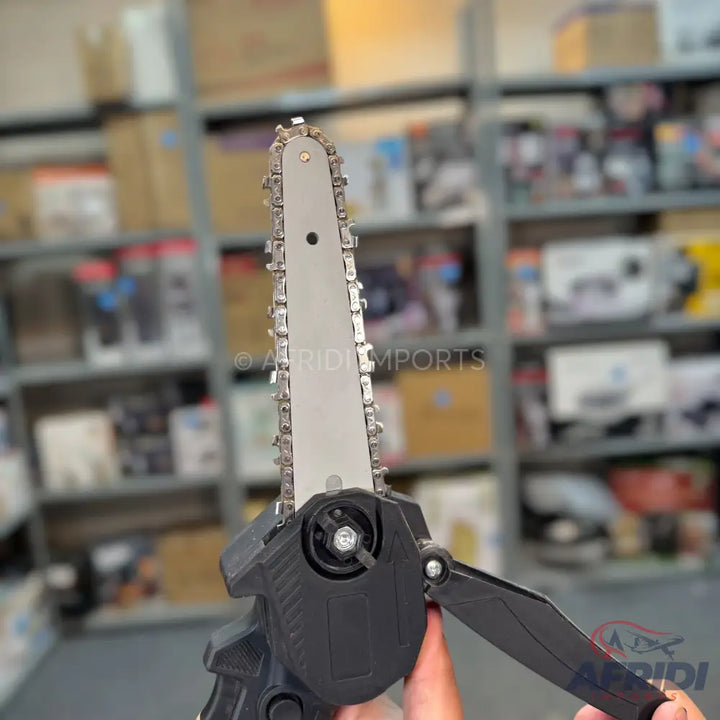 A compact, handheld electric chainsaw with a black body and a silver guide bar and chain.