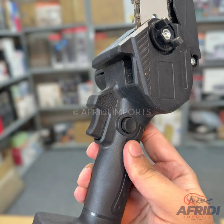 Handheld mini electric chainsaw with a safety button.