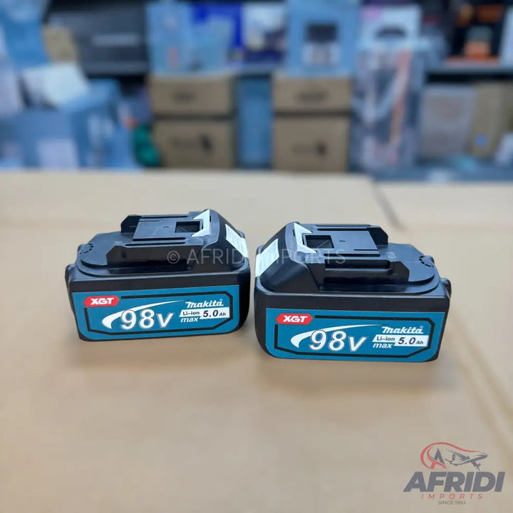 Two black and teal Makita cordless tool batteries.