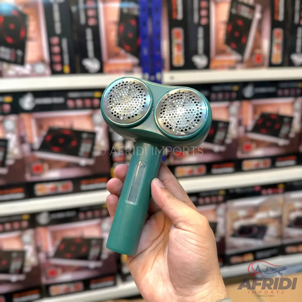 A handheld dual-head fabric shaver with a transparent lint collector.