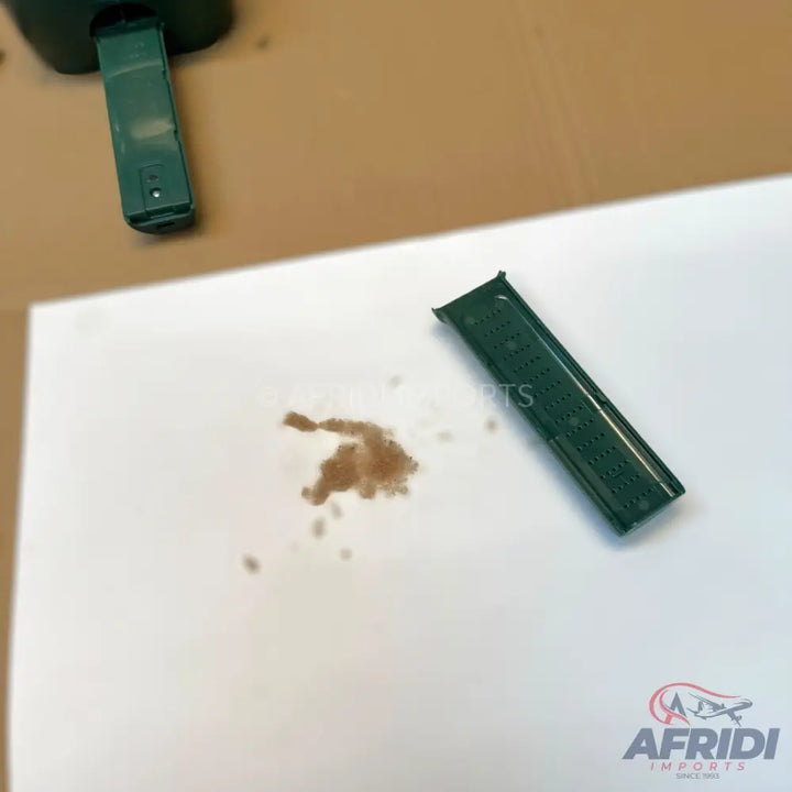 A dark green, perforated silicone watch strap with a buckle.