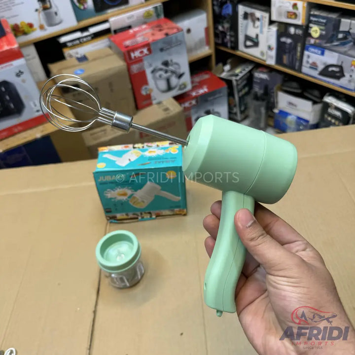 Light green handheld electric whisk with a stainless steel whisk attachment.