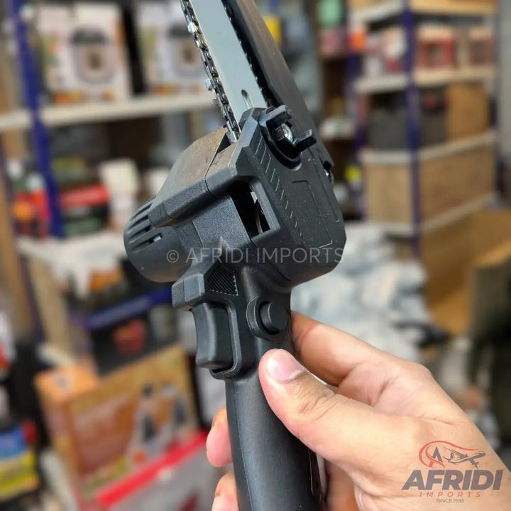 Handheld cordless mini chainsaw with a black body and a metal guide bar.