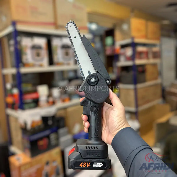 A cordless, handheld mini chainsaw with a black body and a silver chain bar.