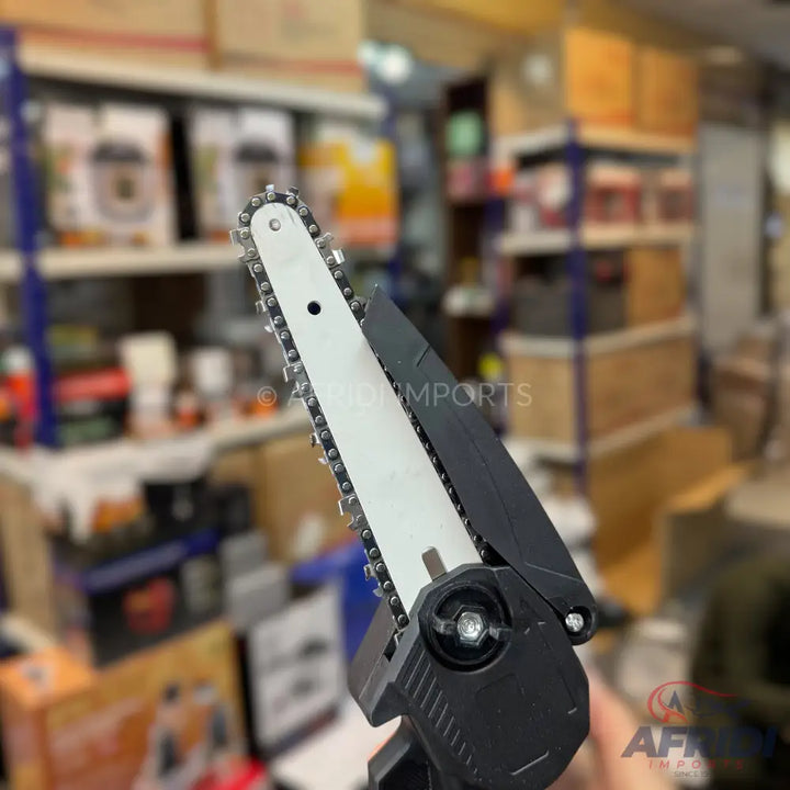 Handheld mini chainsaw with a black handle and a silver blade.
