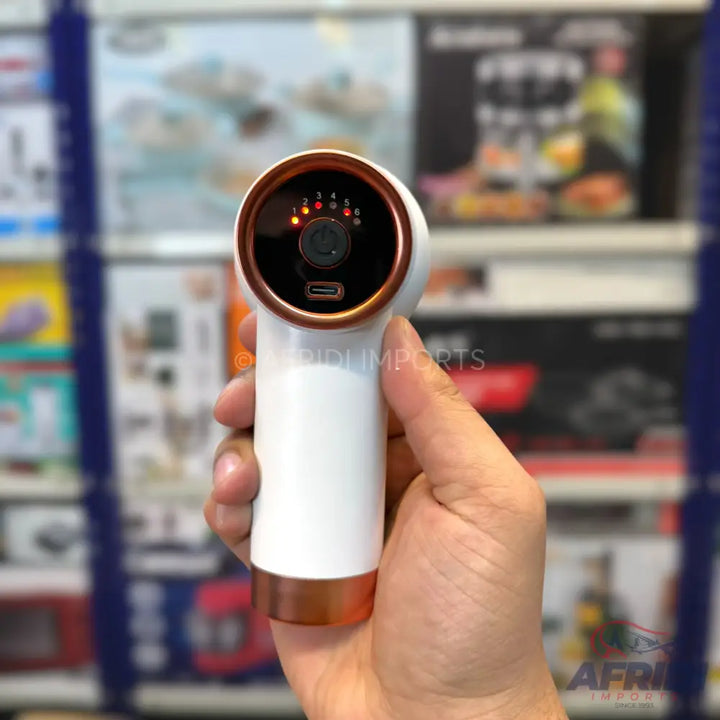 A white and copper handheld mini massage gun with six intensity levels and a USB-C charging port.