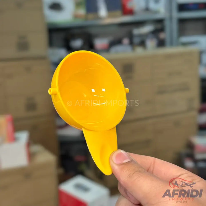 Yellow plastic egg yolk separator.