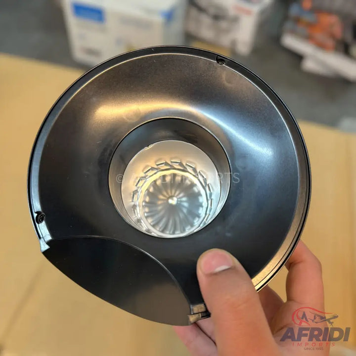 A black, cylindrical car air intake filter with a clear, ribbed internal component.
