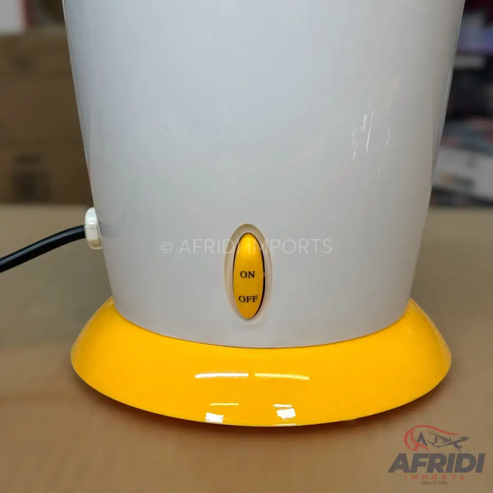 White and yellow electric kettle with an on/off switch.