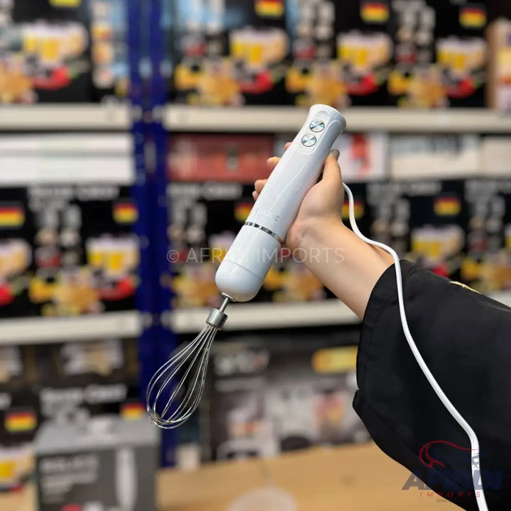 White hand blender with a whisk attachment.