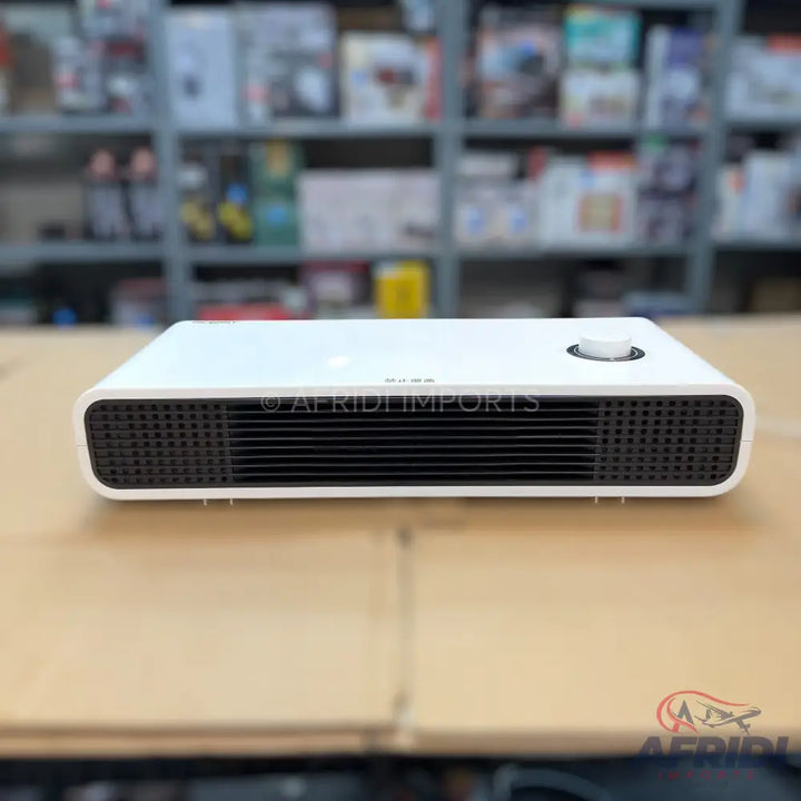 White rectangular portable electric heater with front grilles and a top control knob.