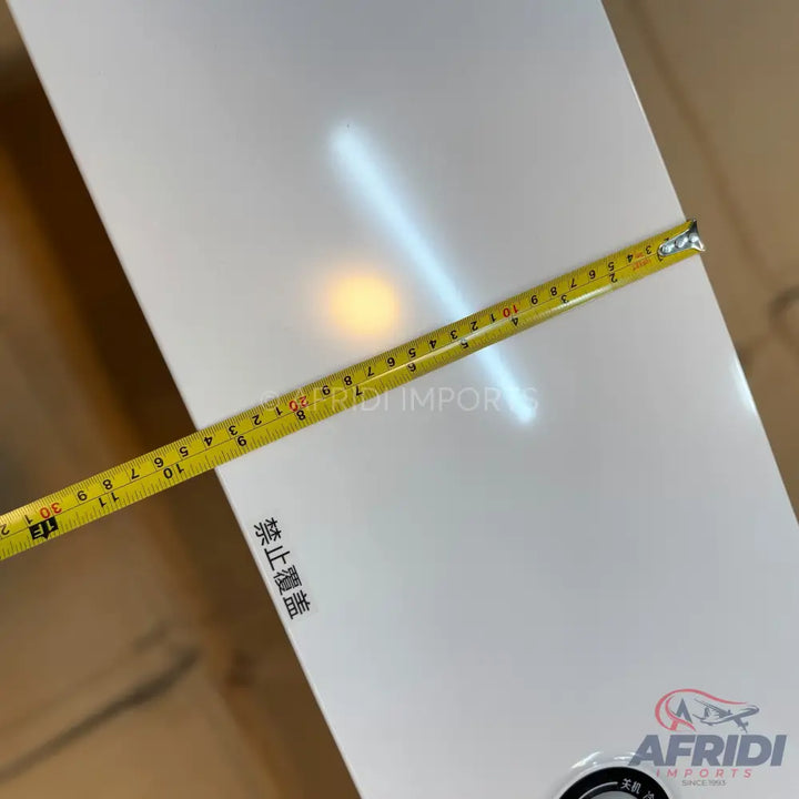 White rectangular panel being measured with a yellow tape measure.