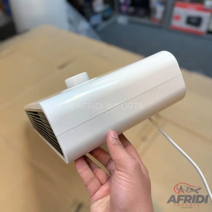 A white, portable electric space heater with a top-mounted control knob and a front-facing grill.