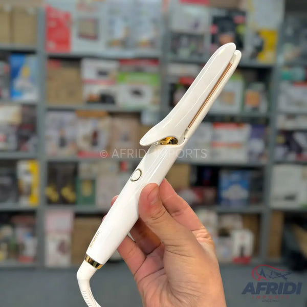 A white and gold hair straightener with a power button.